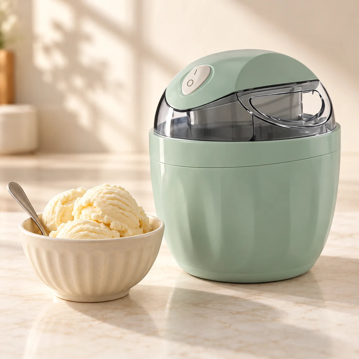 Mint Frostly maker beside a bowl of homemade vanilla ice cream